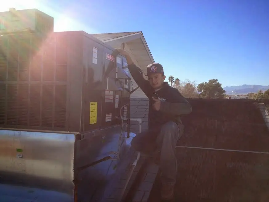 HVAC technician performing HVAC Inspection on a rooftop unit in White Rock